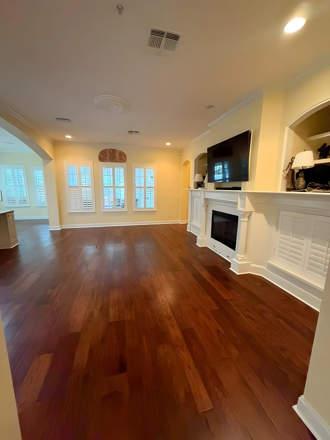 Hand-scraped hardwood floor in a living room with fireplace
